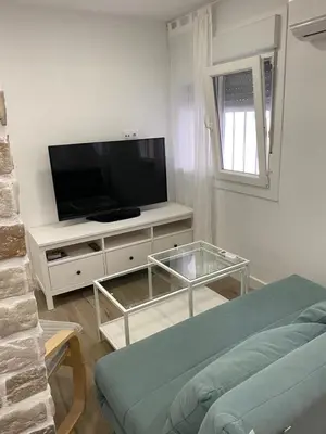 a living room with a flat screen tv and a couch at Playa Apartamento Lidia in Cádiz