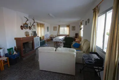a living room with a couch and a fireplace at Vivienda Rural Cortijo de Liche in Arcos de la Frontera