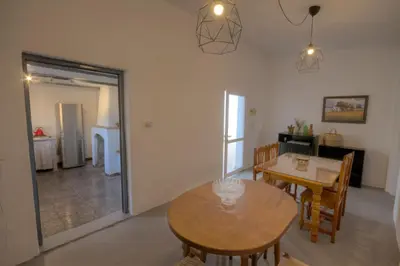 a living room with a table and a dining room at Vivienda Rural Cortijo de Liche in Arcos de la Frontera