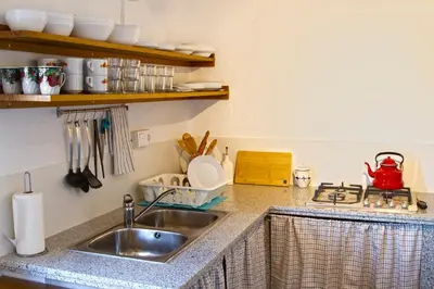 a kitchen counter with a sink and a stove at Vivienda Rural Cortijo de Liche in Arcos de la Frontera