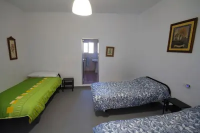 a room with three beds in a room at Vivienda Rural Cortijo de Liche in Arcos de la Frontera