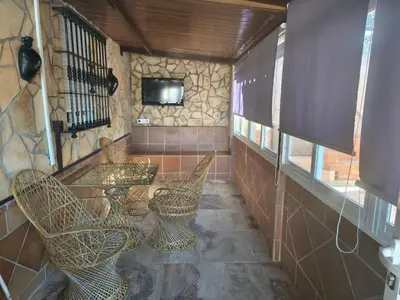 a kitchen with a brick counter with a microwave and stools at RURAL EL SANTISCAL in Arcos de la Frontera
