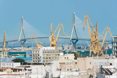 a view of a bridge with cranes in a city at Estudio Las Navas in Cádiz