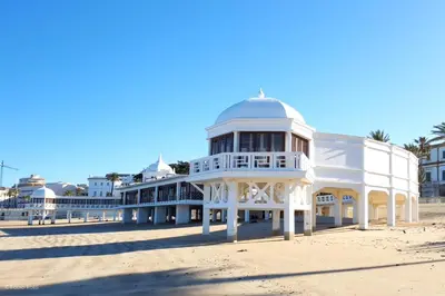 a large white building on the beach at Estudio Las Navas in Cádiz