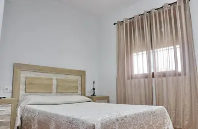 a bedroom with a bed and a window at Villa Ana in Conil de la Frontera