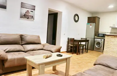 a living room with a couch and a table at Villa Ana in Conil de la Frontera
