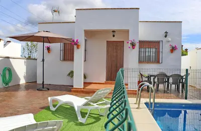 a villa with a swimming pool and a house at Villa Ana in Conil de la Frontera