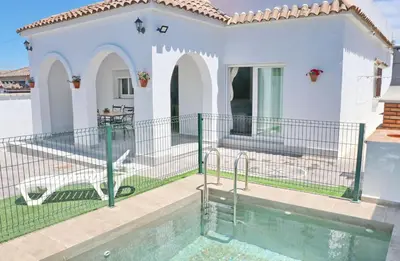a villa with a swimming pool and a house at Villa Alonso in Conil de la Frontera