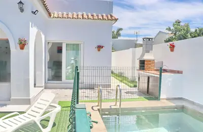 a villa with a swimming pool and a house at Villa Alonso in Conil de la Frontera