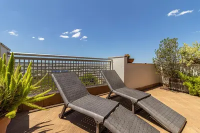 two chairs sitting on a patio with a fence at Mirador del Sur Penthouse & SunSet - Free Parking in Jerez de la Frontera