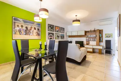 a dining room with a table and a couch at Mirador del Sur Penthouse & SunSet - Free Parking in Jerez de la Frontera