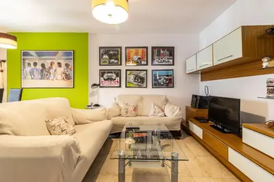 a living room with a couch and a tv at Mirador del Sur Penthouse & SunSet - Free Parking in Jerez de la Frontera