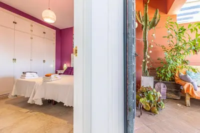a room with a table in a room with purple walls at Mirador del Sur Penthouse & SunSet - Free Parking in Jerez de la Frontera