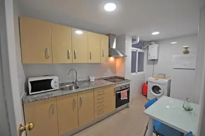 a small kitchen with a sink and a microwave at Laguna 3 dormitorios Acogedor in Cádiz