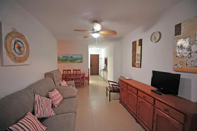 a living room with a couch and a flat screen tv at Laguna 3 dormitorios Acogedor in Cádiz