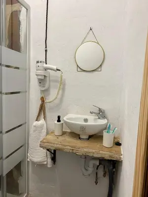 a bathroom with a sink and a mirror at El Jardín de Lucas in Arcos de la Frontera