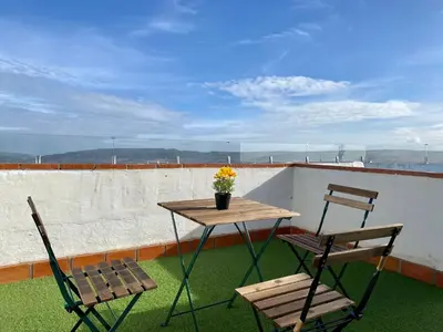 two chairs and a table and two chairs on a balcony at El Jardín de Lucas in Arcos de la Frontera