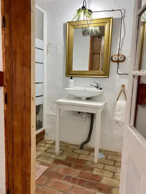 a bathroom with a white sink and a mirror at El Jardín de Lucas in Arcos de la Frontera