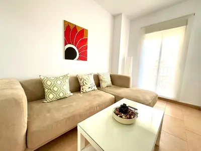 a living room with a couch and a table at Mirador de Doñana Nº 14, Apartamentos Living Sur in Sanlúcar de Barrameda