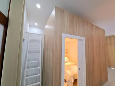 a room with a ladder leading to a bedroom at Apartamento Barrosa Pista in Chiclana de la Frontera