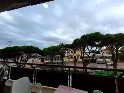a view from a balcony of a parking lot with trees at Apartamento Barrosa Pista in Chiclana de la Frontera