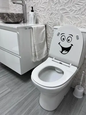 a bathroom with a toilet with a smiley face drawn on it at Molineros Victoria Beach in Cádiz