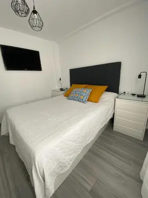 a white bed with two pillows on it in a bedroom at Molineros Victoria Beach in Cádiz