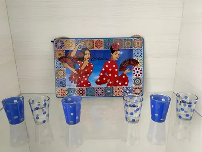 a group of blue glasses on a shelf with a picture at Molineros Victoria Beach in Cádiz