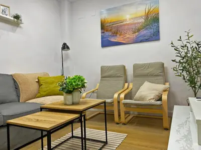 a living room with a couch and two chairs at Apartamento Alborada - Ole Solutions in Sanlúcar de Barrameda