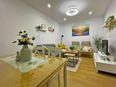 a living room with a couch and a table at Apartamento Alborada - Ole Solutions in Sanlúcar de Barrameda