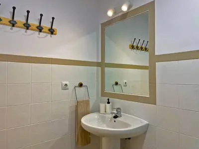 a bathroom with a sink and a mirror at Apartamento Alborada - Ole Solutions in Sanlúcar de Barrameda