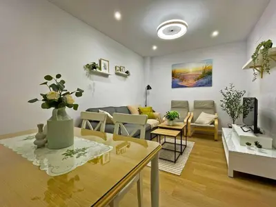 a living room with a couch and a table at Apartamento Alborada - Ole Solutions in Sanlúcar de Barrameda
