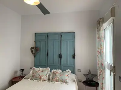 a bedroom with a blue cabinet and a bed with pillows at Apartamento Residencial Al Andalus 117, La Barrosa, Chiclana, Incluye parking a unos metros del mar in Chiclana de la Frontera