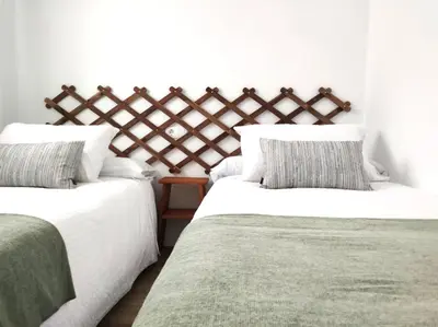 two beds sitting next to each other in a bedroom at La Terraza de Natipao in Rota