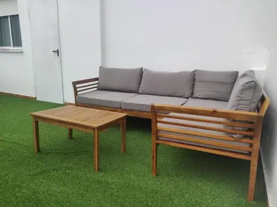 a couch and a coffee table in a room at La Terraza de Natipao in Rota