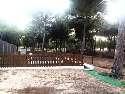 a wooden fence in a park with trees at Casa Selene in El Puerto de Santa María