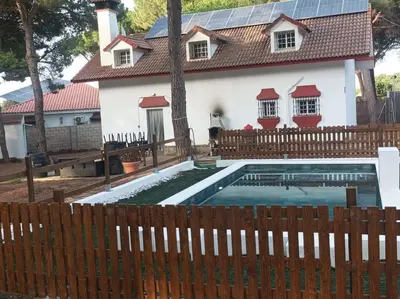 a house with a swimming pool in front of a fence at Casa Selene in El Puerto de Santa María