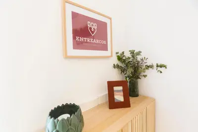 a living room with plants and a picture on the wall at ENTREARCOS in Cádiz