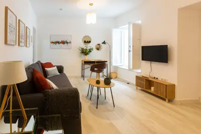a living room with a couch and a tv at ENTREARCOS in Cádiz