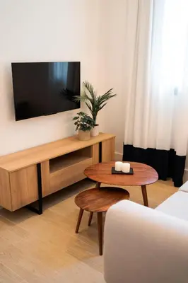 a living room with a tv and a coffee table at CISNES PALACE in Sanlúcar de Barrameda
