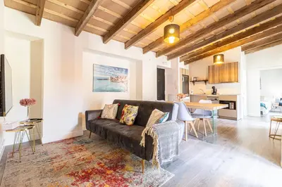 a living room with a couch and a table at Casa Palacio Rufina & Jardines in Jerez de la Frontera