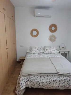 a bedroom with a bed and two mirrors on the wall at VILLA SANCTI PETRI in Chiclana de la Frontera