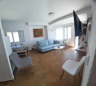 a living room with a blue couch and chairs at VILLA SANCTI PETRI in Chiclana de la Frontera
