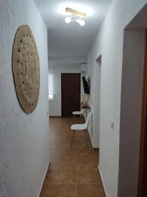 a hallway with a room with a table and a chair at VILLA SANCTI PETRI in Chiclana de la Frontera