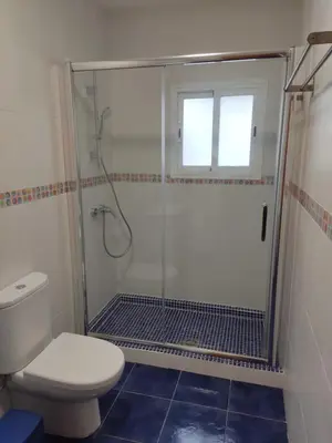 a bathroom with a glass shower with a toilet at VILLA SANCTI PETRI in Chiclana de la Frontera