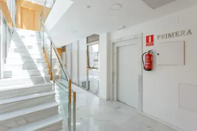 a staircase in a building with a fire hydrant on the wall at Sherryflat Abrantes - Parking in Jerez de la Frontera