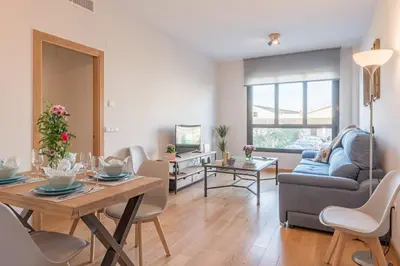 a living room with a table and a couch at Sherryflat Abrantes - Parking in Jerez de la Frontera