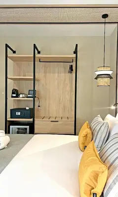 a bedroom with a large white bed with yellow pillows at Soho Boutique Columela in Cádiz