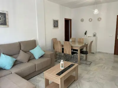 a living room with a couch and a table at Apartamento Centro Playa in Sanlúcar de Barrameda