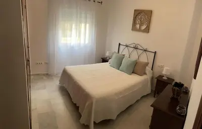 a bedroom with a bed and a window at Apartamento Centro Playa in Sanlúcar de Barrameda